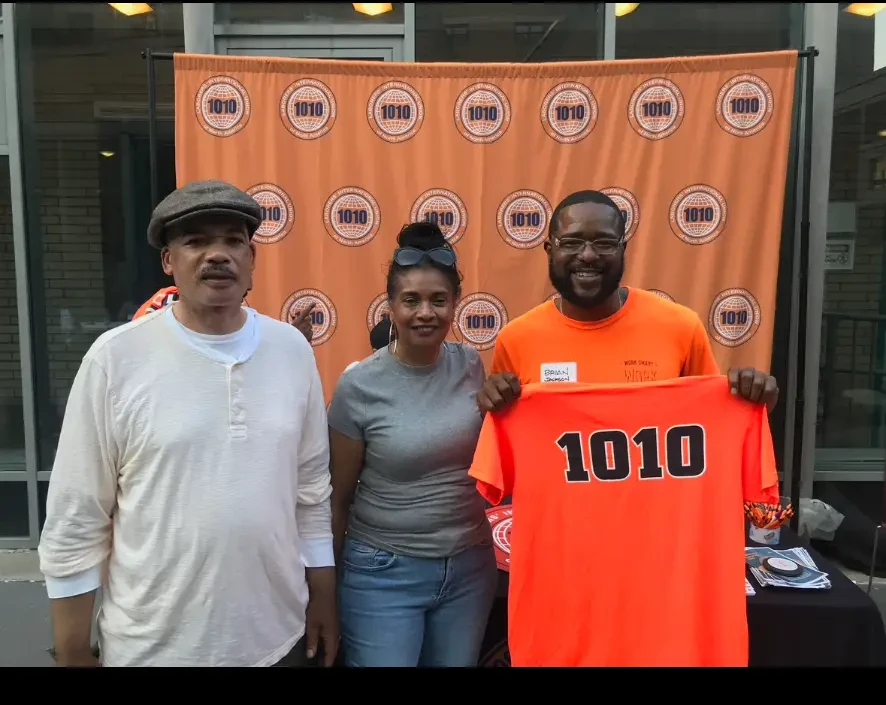Three community members together at a construction community event
